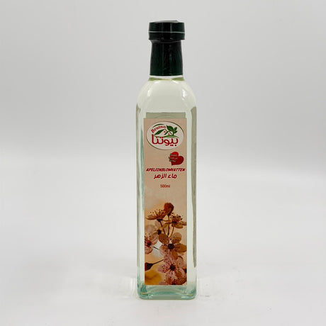 A clear glass bottle of olive oil with a black cap and a beige label featuring Arabic text, a green leaf logo, and a floral illustration, set against a plain light gray background.